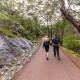 A couple walks along a trail at Serpentine National Park